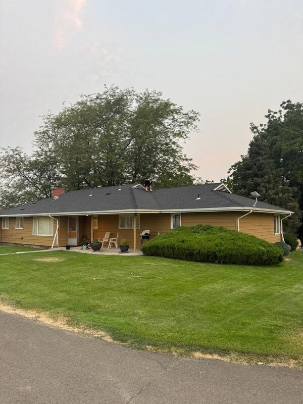 Completed home with brand new dark architectural shingle roof