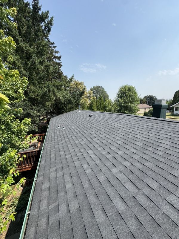 Street view of a new construction home with a finished architectural shingle roof